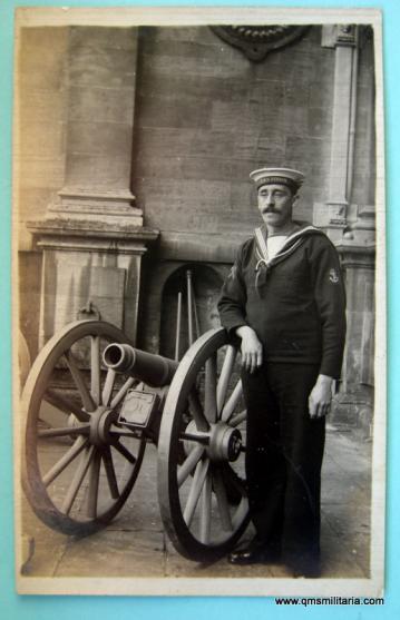 WW1 vintage original postcard of Royal Navy Sailor of HMS Vernon posing next a Naval Brigade style gun