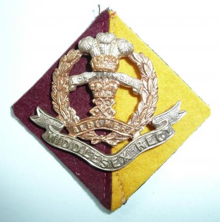The Middlesex Regiment ( 57th & 77th Foot) Other Ranks Bi-metal Issue Cap Badge with Original Felt Regimental Backing Cloth